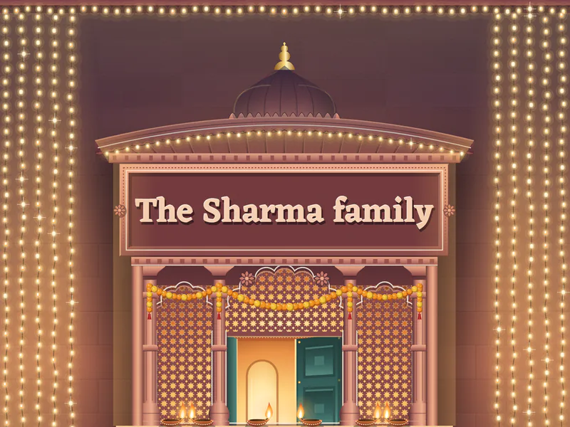 The name the Sharma family carved on the plaque under a lit haveli window, close up